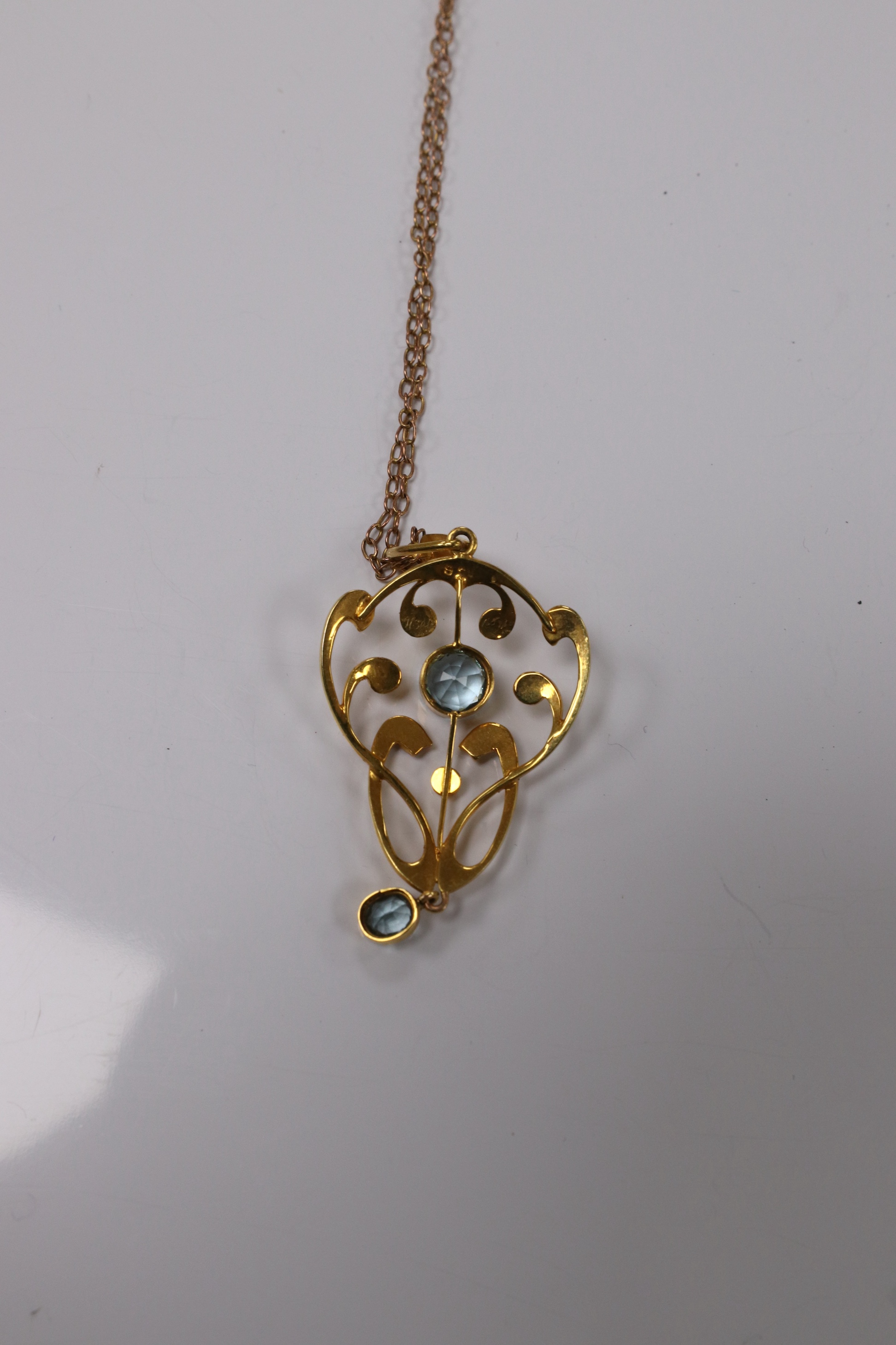 An Edwardian 9ct and gem set drop pendant, 45mm, on a yellow metal fine link chain, 36cm, gross weight 4.2 grams. Condition - good